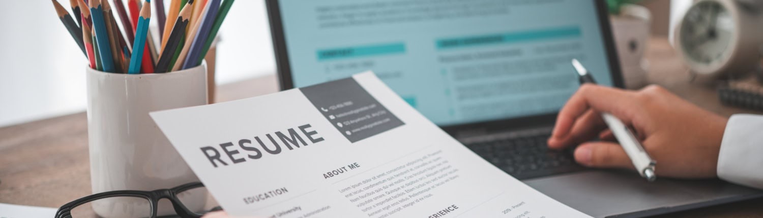 People are reviewing job applications before filling out their resume on the job application form in order to apply for a job at a company.